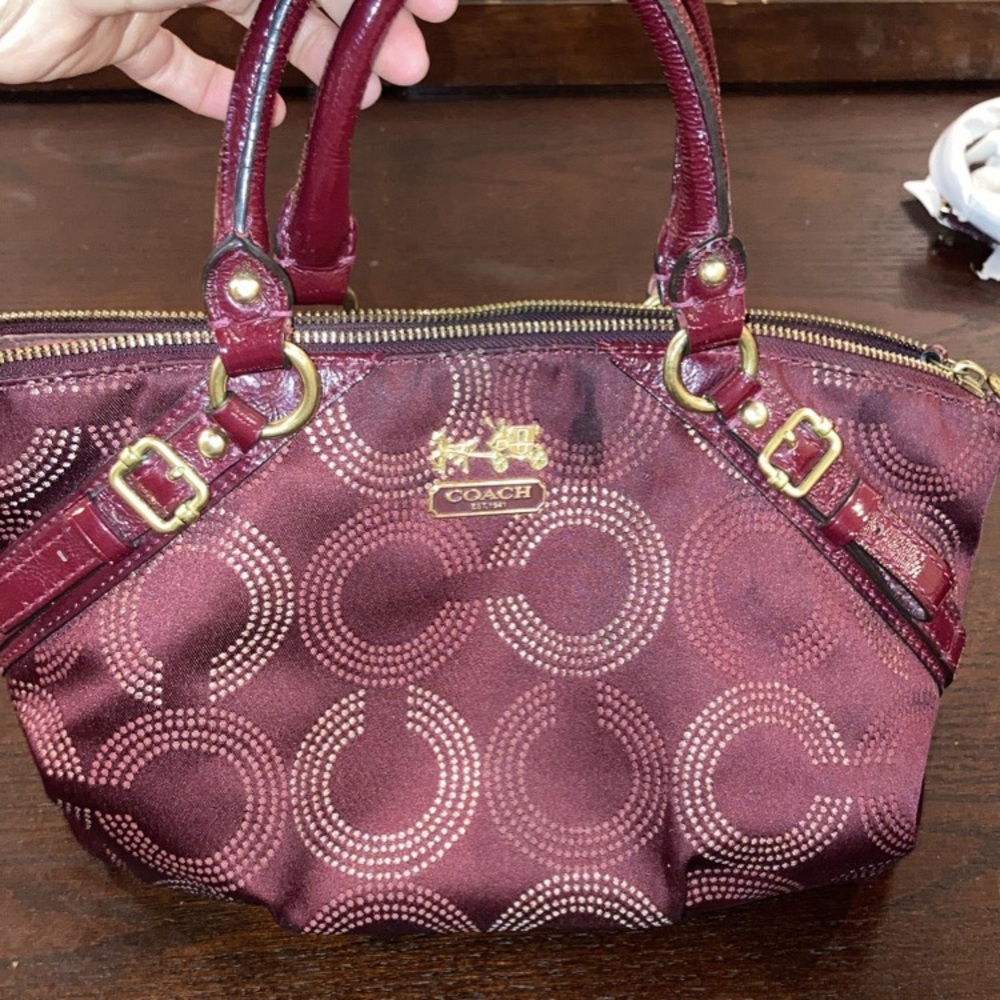 Wine/gold COACH satchel.